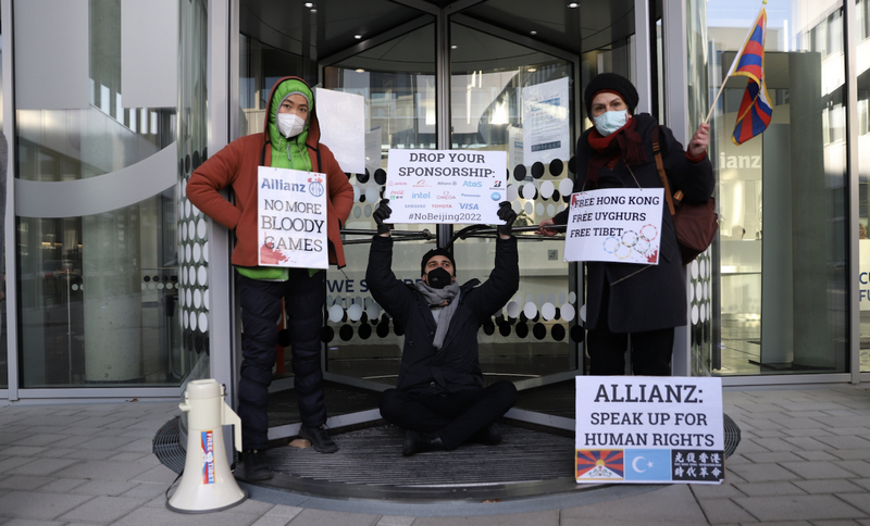 Activists chain themselves to the doors of Allianz headquarters in Berlin on 21 January 2022 to protest against the company's sponsorship of the Beijing Olympics. Photo: TPI