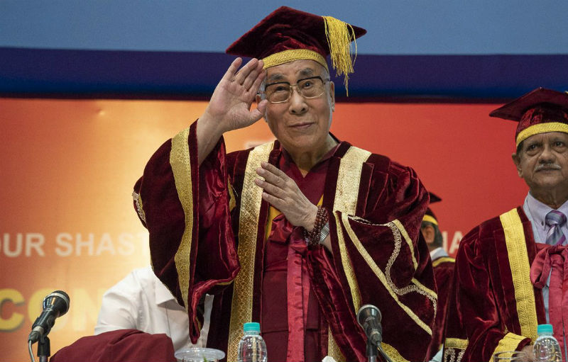 His Holiness the Dalai Lama waving to the audience as he takes his seat at the dias at the start of the Lal Bahadur Shastri Institute of Management Convocation in Delhi, India on April 23, 2018. Photo by Tenzin Choejor
