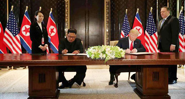 Trump and Kim Jong Un prepare to sign a document at the Capella hotel on Singapore’s Sentosa island on Tuesday, June 12, 2018. Photo: Reuters
