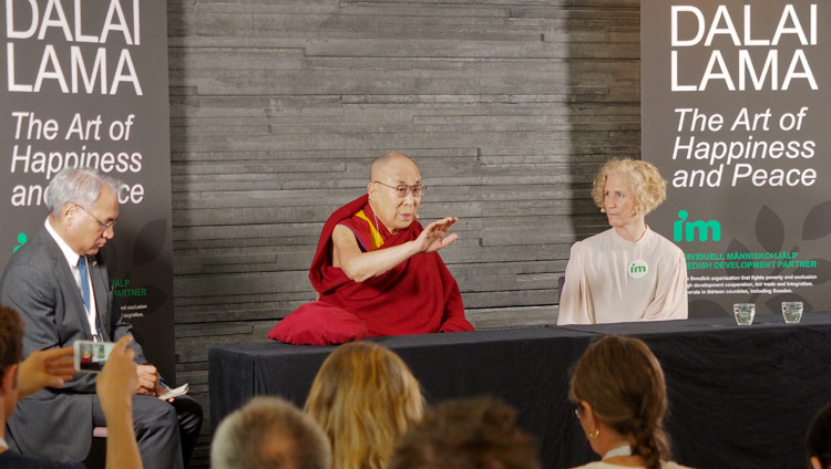 Secretary General of IM Ann Svensén looks on as His Holiness the Dalai Lama addresses members of the press in Malmö, Sweden on September 12, 2018. Photo by Jeremy Russell