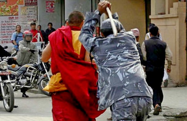 A Nepalese policeman torturing a Tibetan monk during a peaceful protest in Nepal, many say that Nepal is just a puppet of the PRC. Photo: File