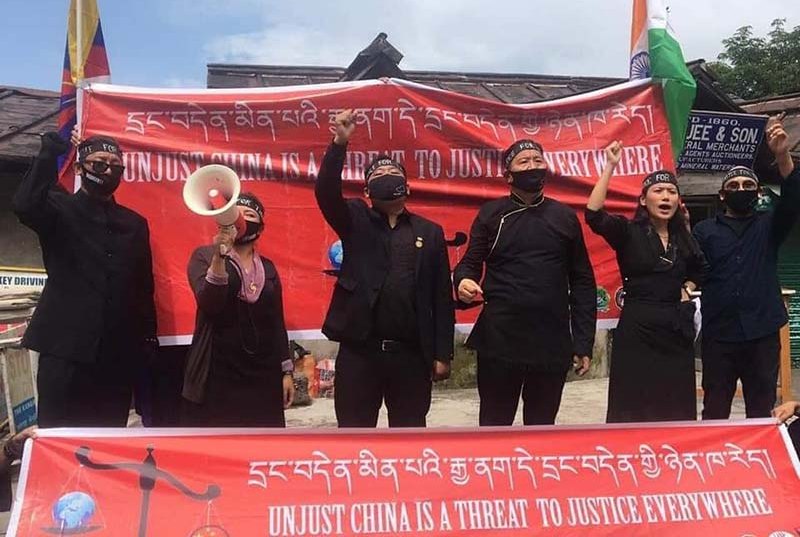 Tibetan activists from the five prominent Tibetan NGOs holding banners, calling "Unjust China is a threat to justice everywhere", in Dharamshala, India, on July 17, 2020. Photo: TPI